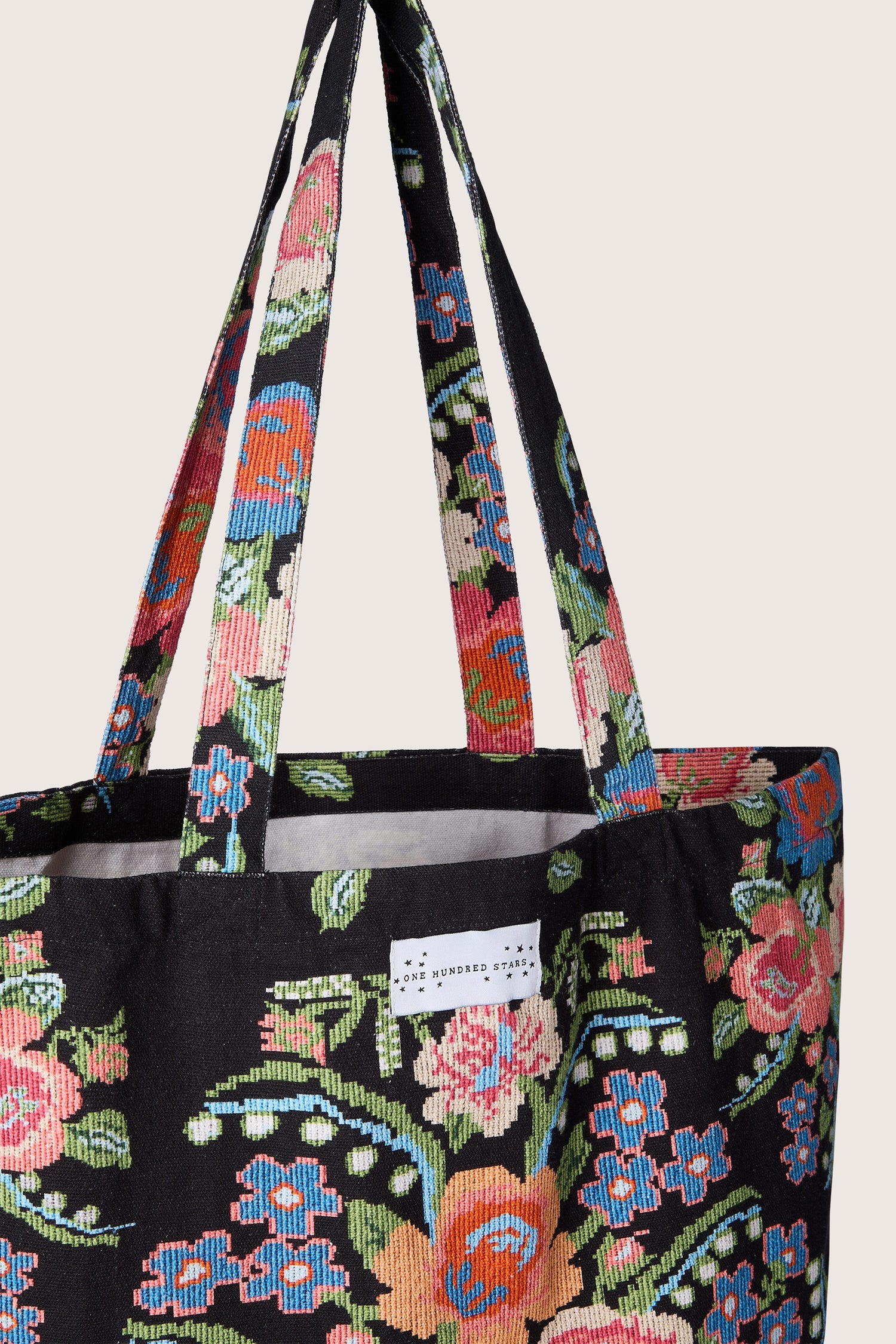 An eco-friendly black Woven Flower Canvas Bag, made from sustainable cotton for an elegant and stylish look.