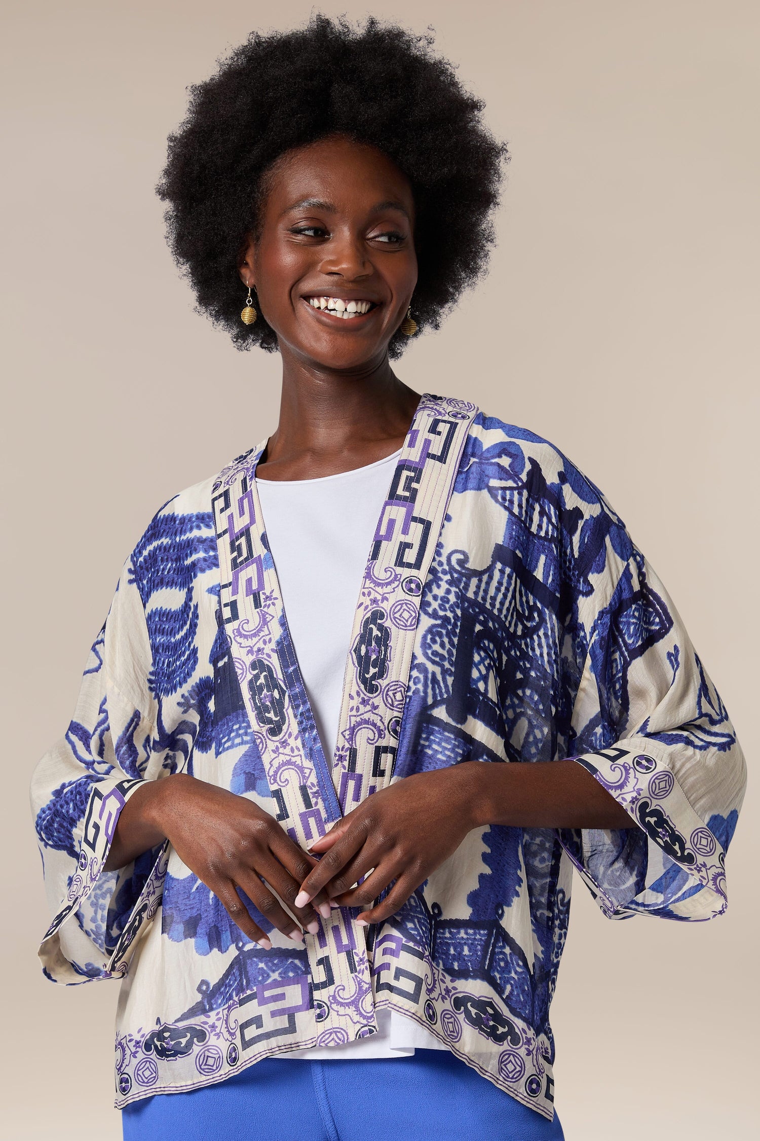 A woman wearing the Willow Kimono, a lightweight kimono jacket with a print of blue and white.