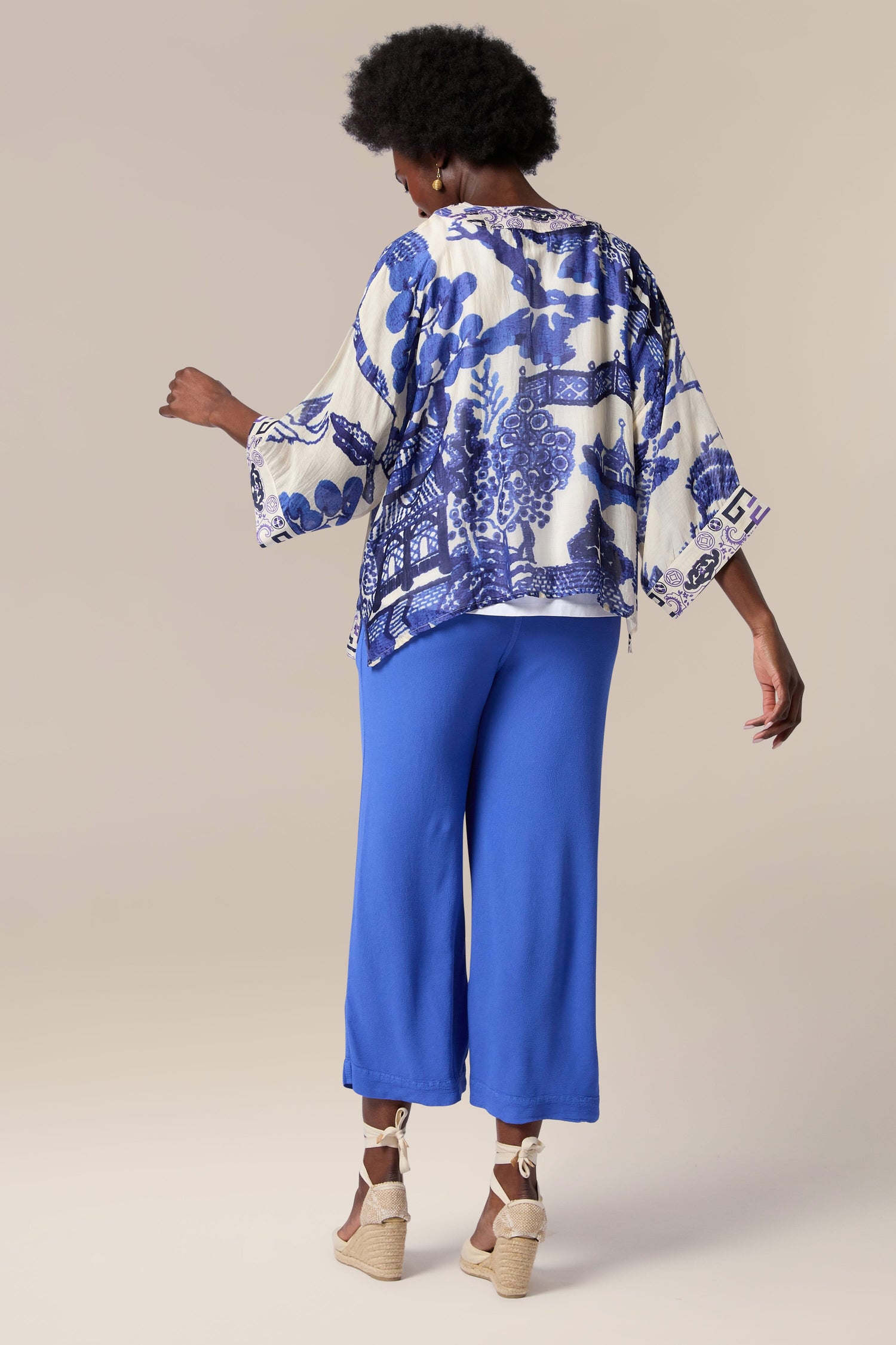 The lightweight and printed Willow Kimono is being worn by a woman, as seen from the back.