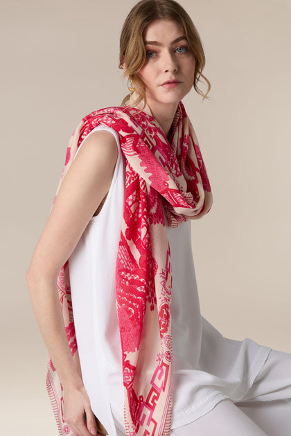 A woman posing in a white top with a Willow Print Scarf draped over her shoulder.