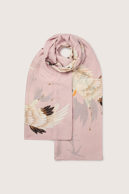 Elegant pink modal Stork Scarf with a crane bird design, draped against a white background.