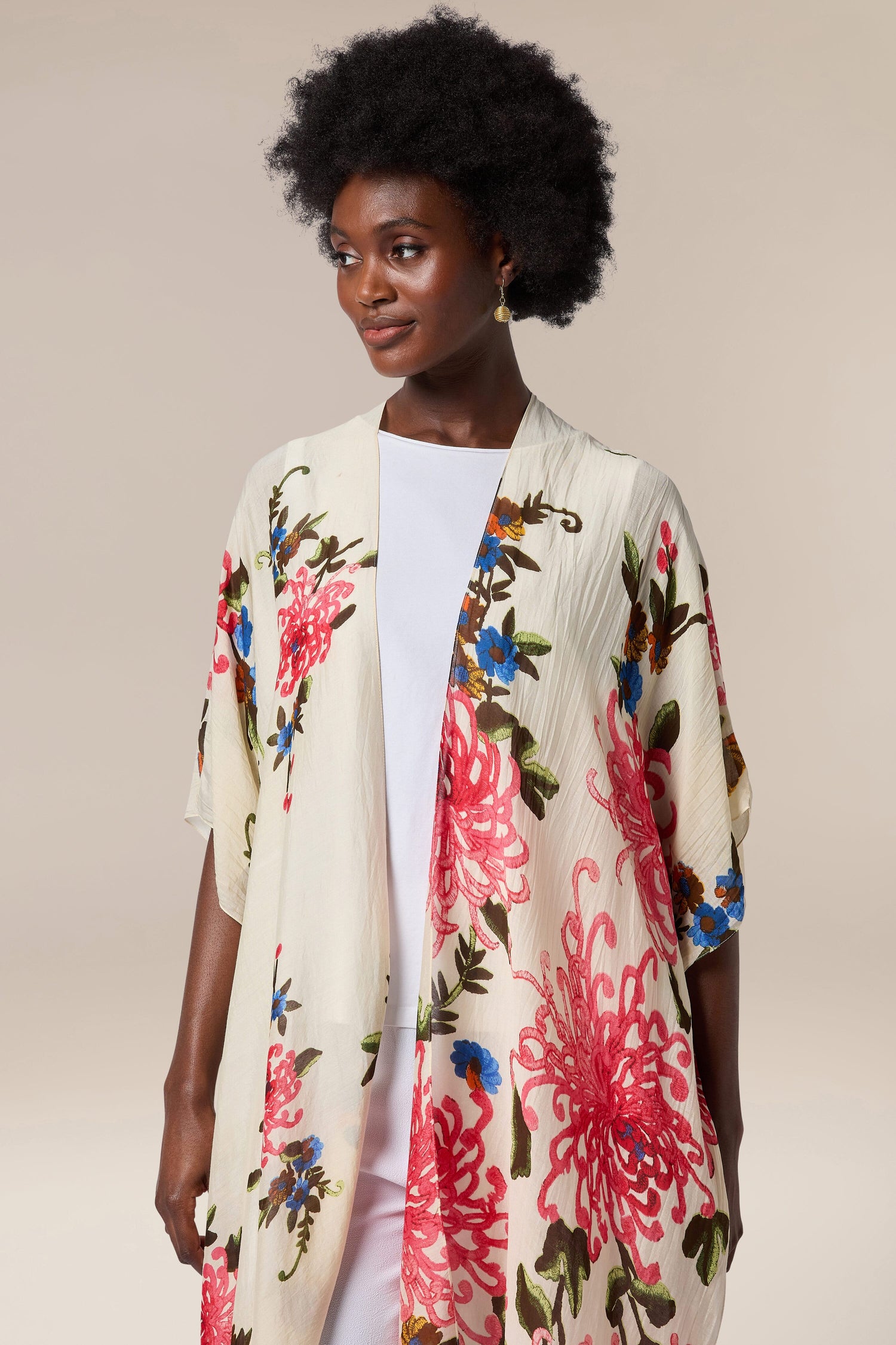 A black woman wearing a Chrysanthemum Throwover by One Hundred Stars.