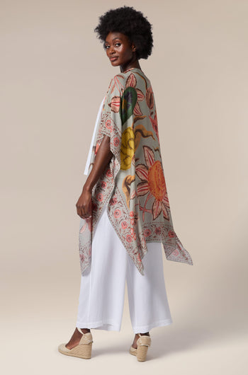 The back view of a woman wearing a floral printed kimono, a Joy Throwover.