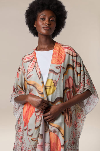 A woman wearing the Joy Throwover, a floral print kimono throwover.