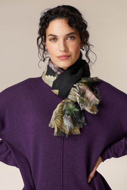 A woman wearing a vintage-inspired purple sweater and Daisy Print Woollen Scarf.