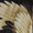 Close-up of the Stork Wool Throwover's multiple beige and light brown bird feathers overlapping each other with a dark background, reminiscent of an Art-Deco stork print.