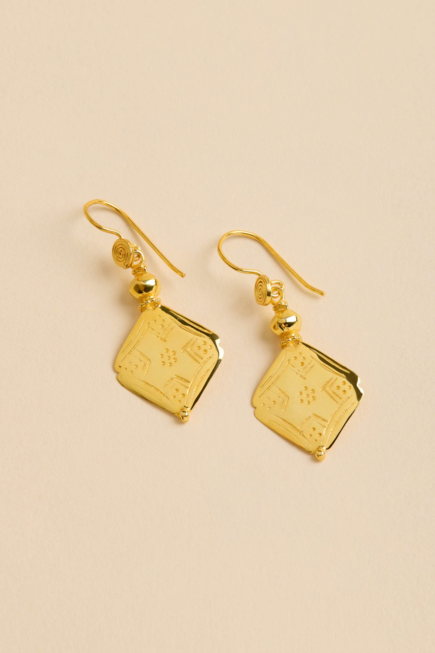 Gold-Plated Square Drop Earrings with engraved square pendants and small round beads, shown on a beige background.