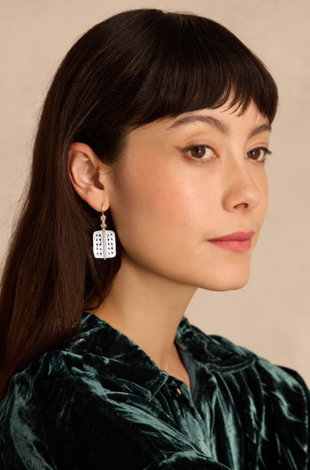 Woman with straight dark hair in a green velvet top wears Filigree Drop Earrings, looking to the side against a neutral background.