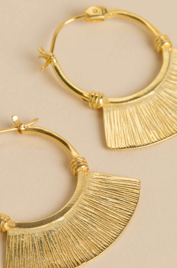 The Gold-Plated Fan Hoop Earrings feature textured hoops with fan-shaped pendants, showcased against a neutral backdrop.