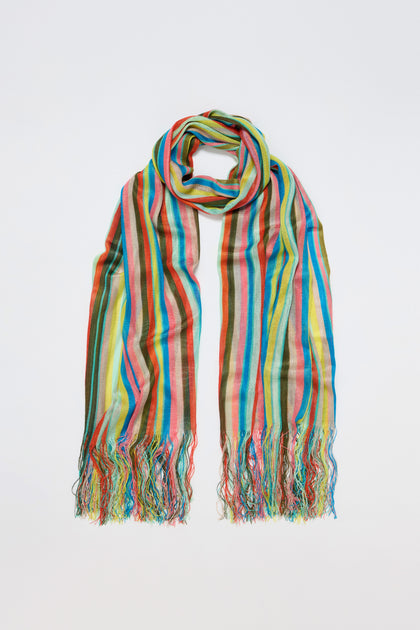 The Colour Spectrum Stripe Viscose Scarf, featuring multicolored vertical stripes and fringed ends, is shown laid flat on a white background.