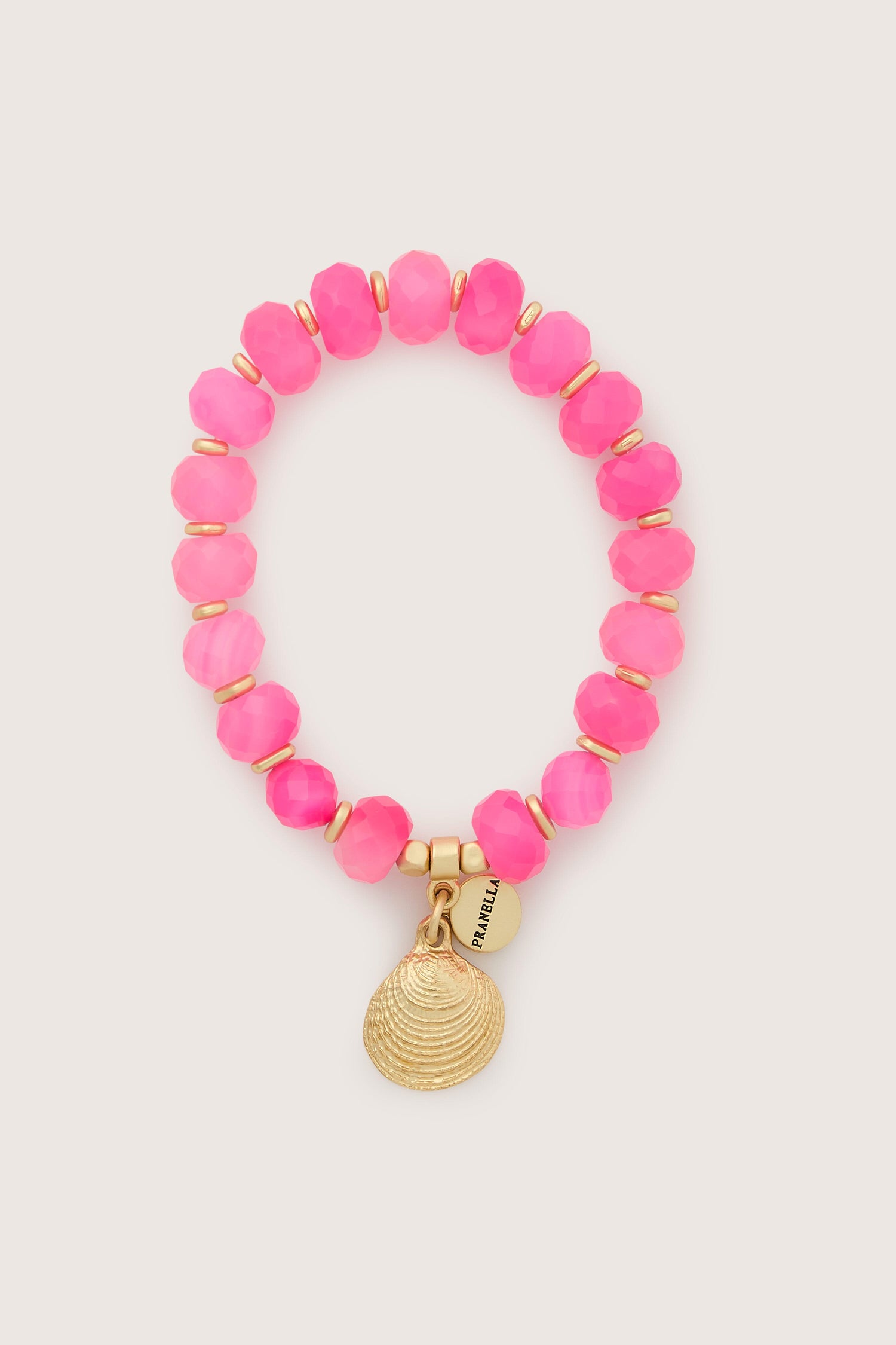 A pink Brazilian Agate beaded bracelet with a gold charm, handcrafted from Brazilian Agate.