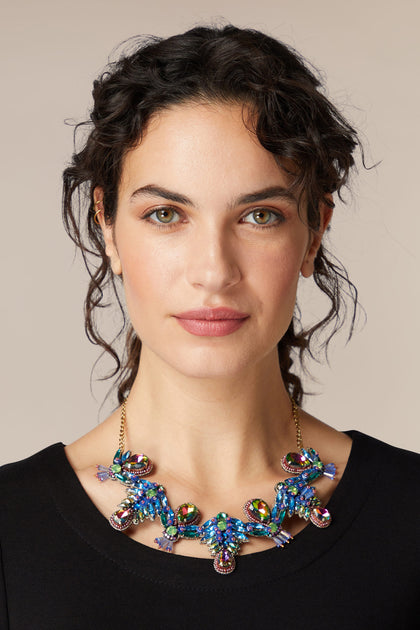 A woman wearing a Hand Beaded Necklace.