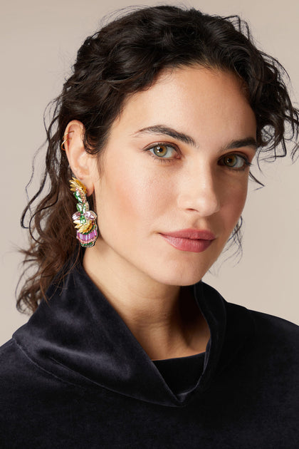 A woman wearing a black sweater and Hand Beaded Earrings.