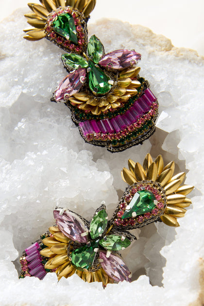 A pair of Hand Beaded Earrings on a rock, exuding sophistication and sparkle.