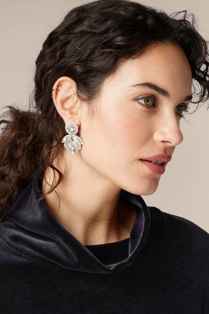 A sophisticated woman wearing a black sweater and the Hand Beaded Flower Earrings that sparkle.