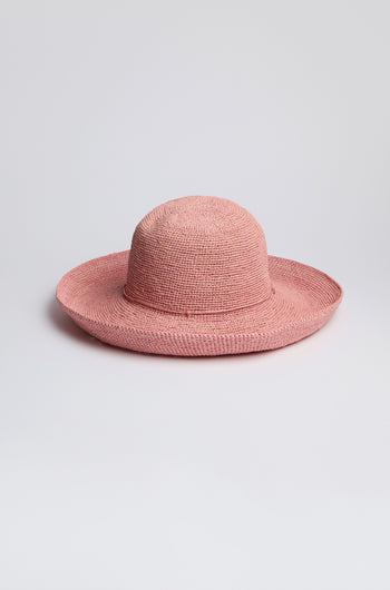 A Handwoven Wide Brim Raffia Hat, offering sun protection, is stylishly placed against a plain white background.