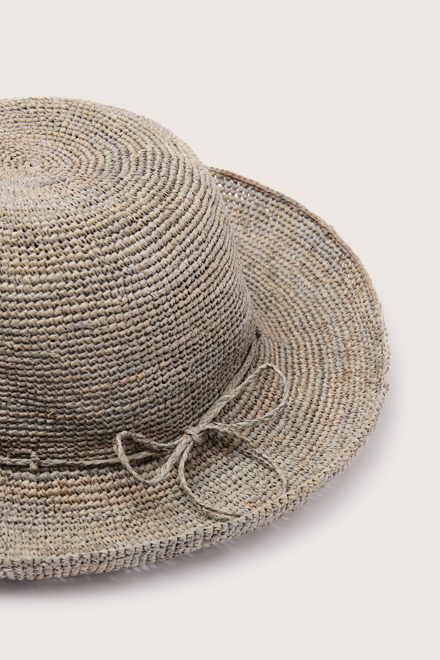 A Woven Raffia Hat with a bow on a white background.