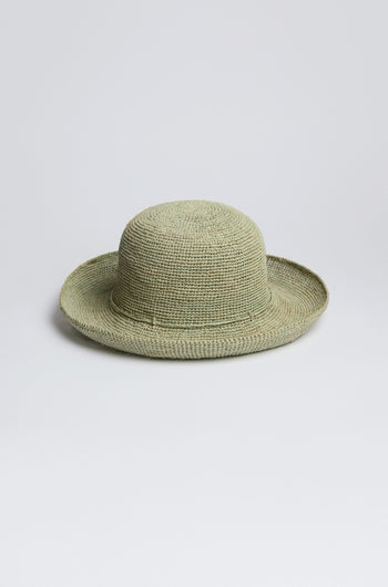 Handwoven in Madagascar, the Sage Handwoven Raffia Hat features a wide brim and circular crown, elegantly presented against a plain white background.