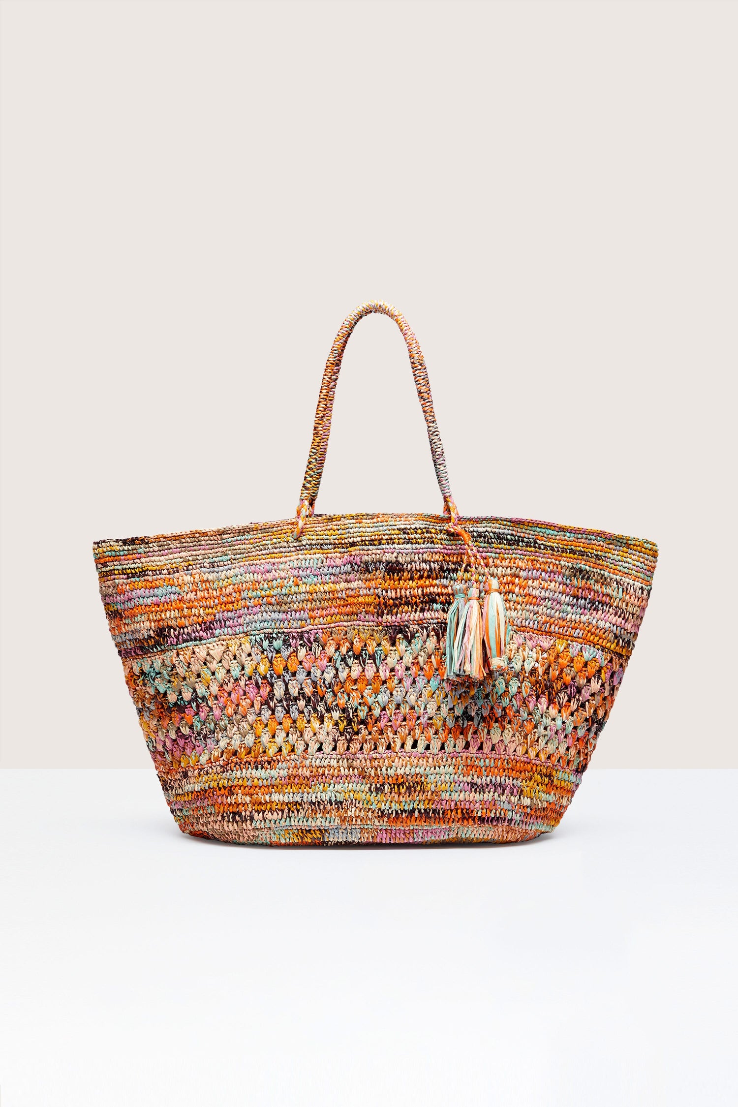 Hand-crafted Woven Rainbow Raffia Bag by Madagascar artisans, set against a neutral background.