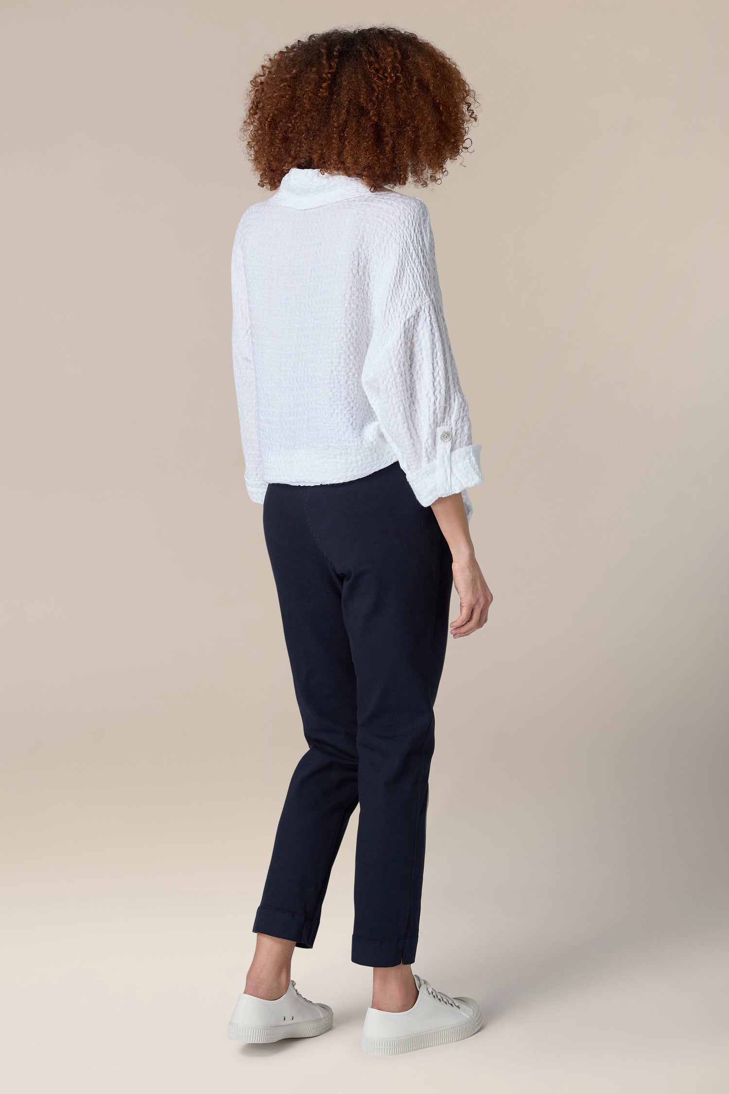 The woman is showcasing a slim silhouette in her Stretch Cotton Slim Trouser.