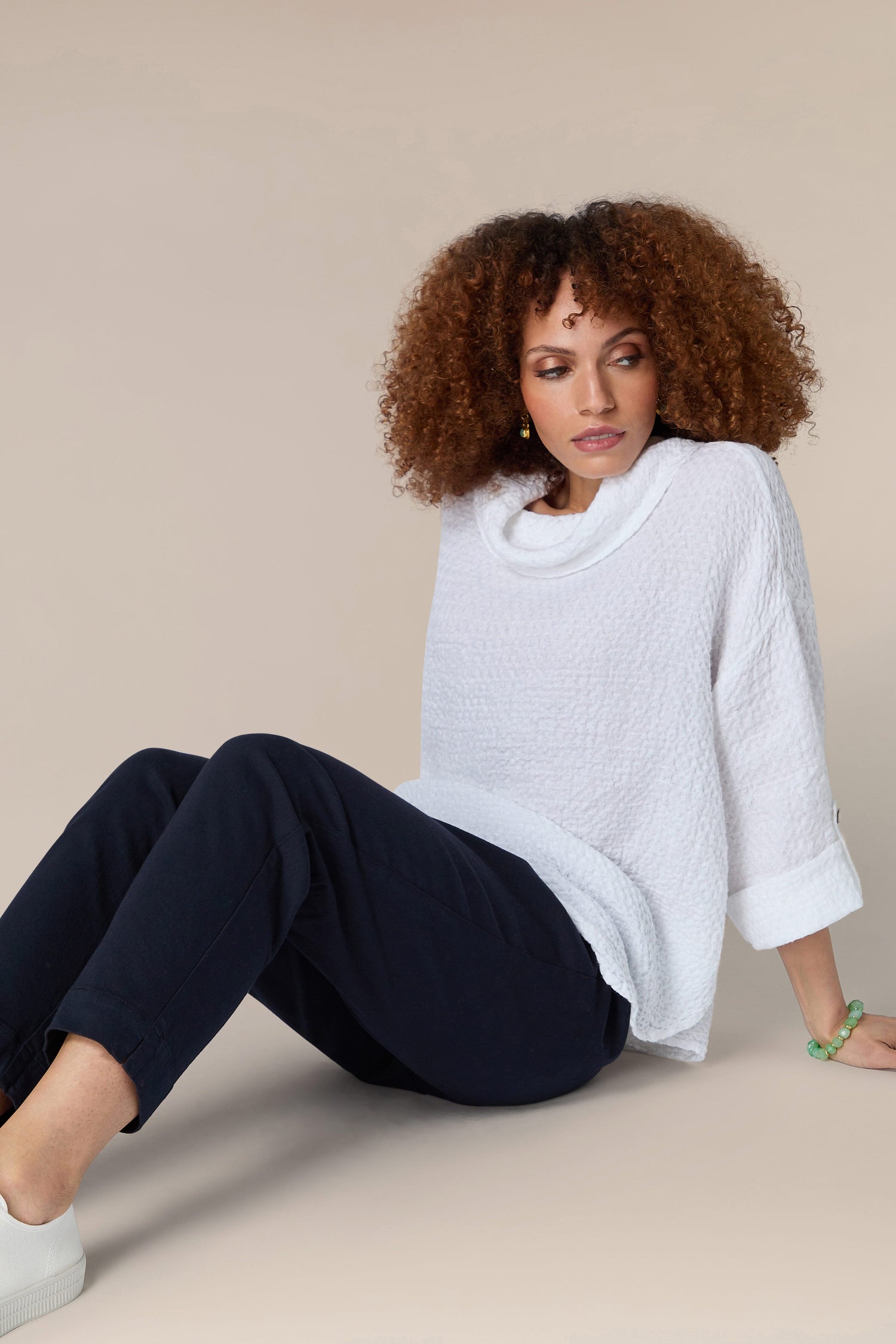 A woman in a white sweater and Stretch Cotton Slim Trouser.