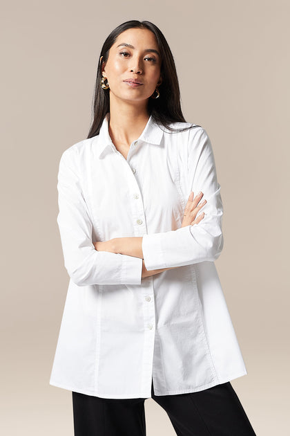 An elegant woman wearing a Paper Cotton Shirt with a collared design and black pants made of breathable cotton.