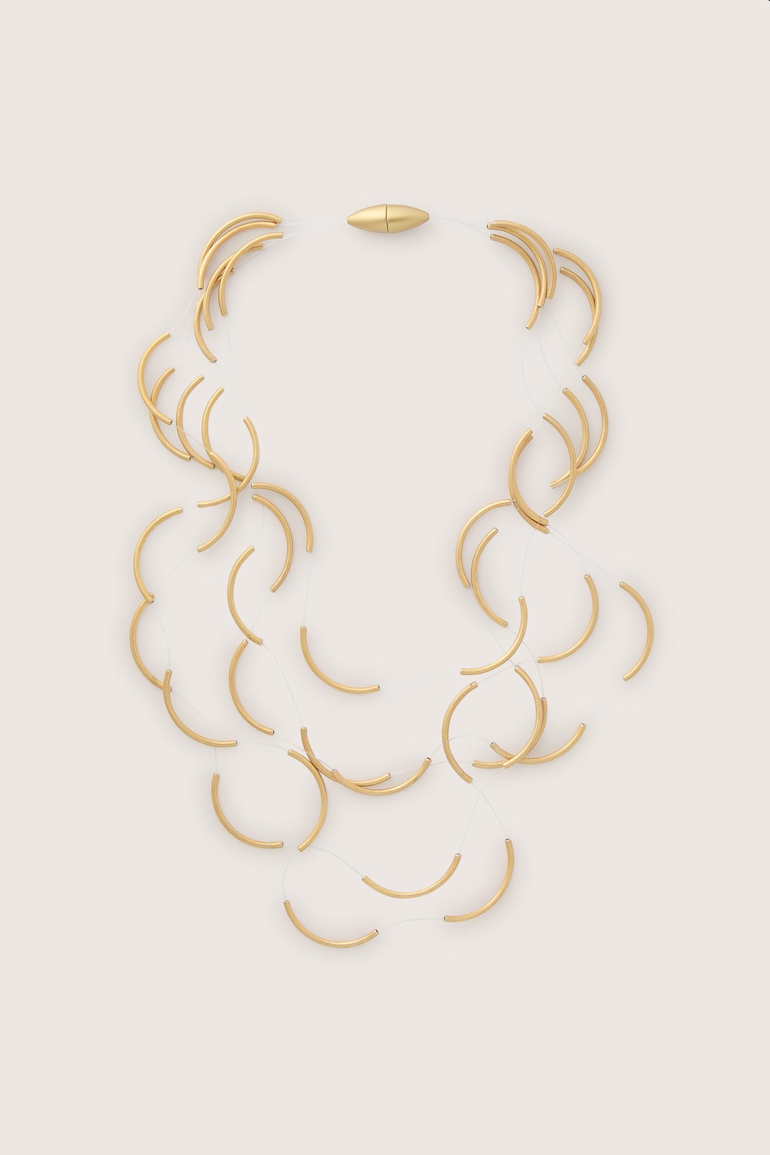 A stunning Moon Necklace featuring floating beads, designed by Rosalba Galati, displayed elegantly on a pristine white background. - Moon Necklace