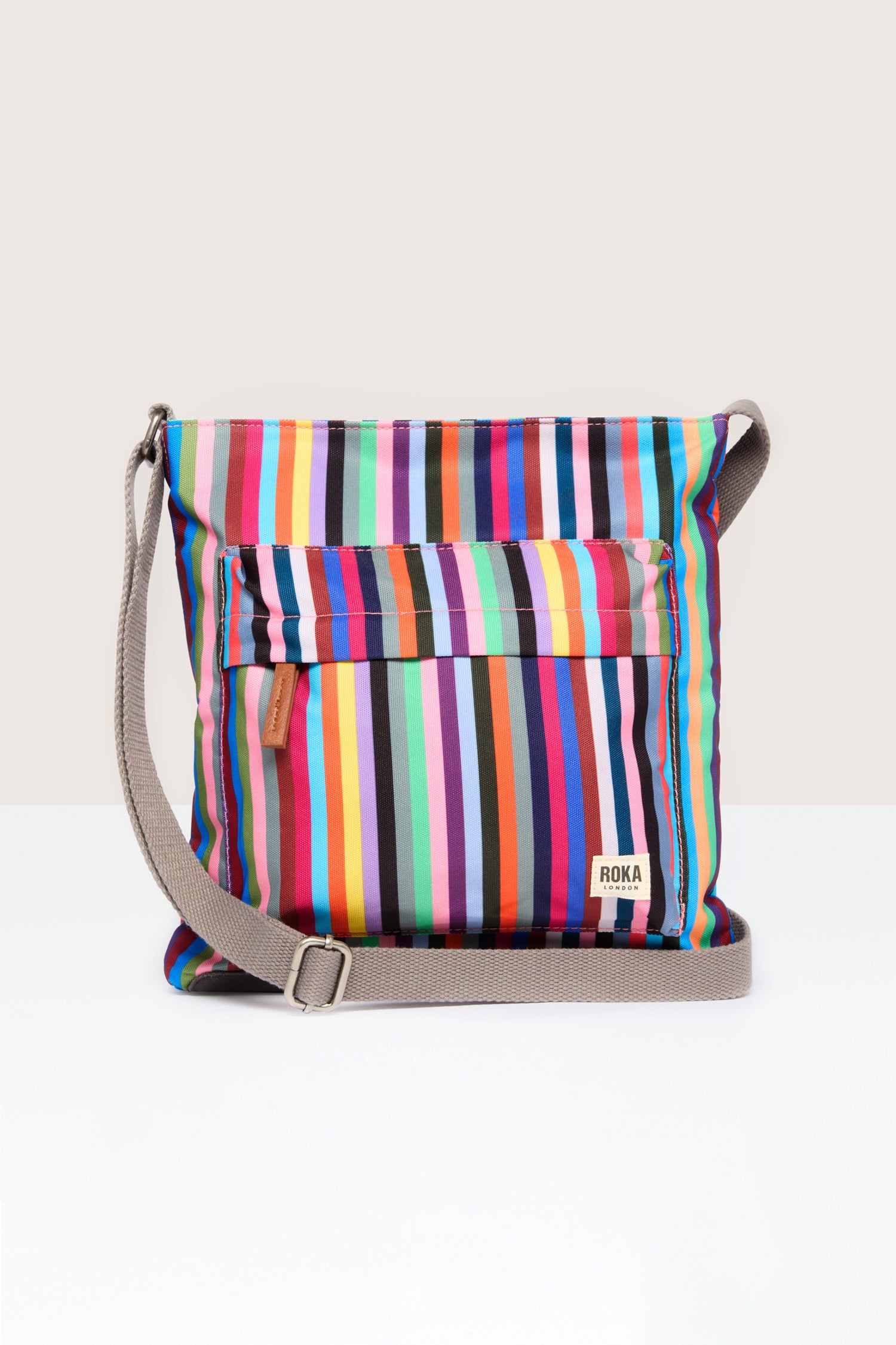 A colorful striped Recycled Canvas Kennington Bag with a shoulder strap.