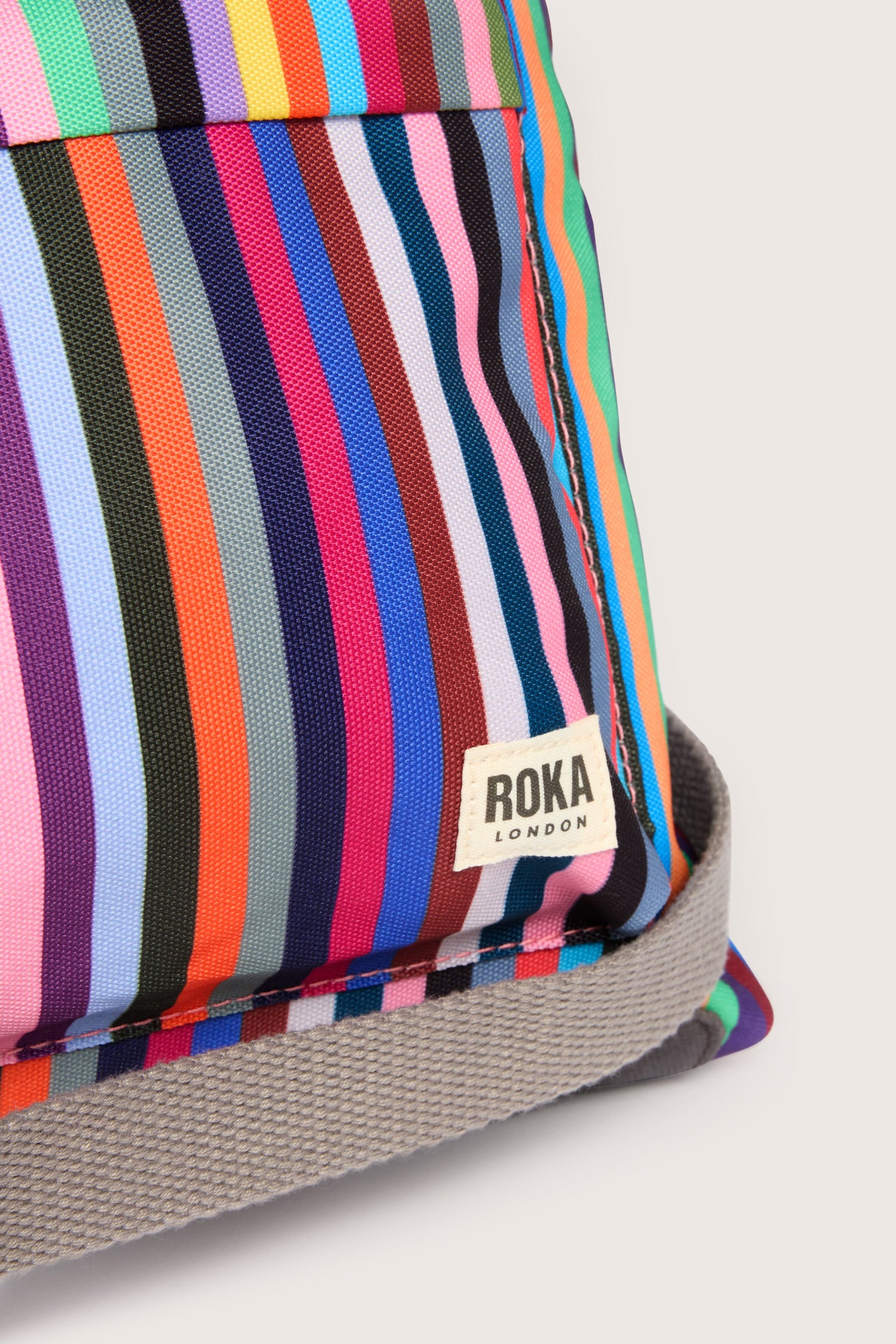 A vibrant striped Recycled Canvas Kennington Bag made of canvas material.