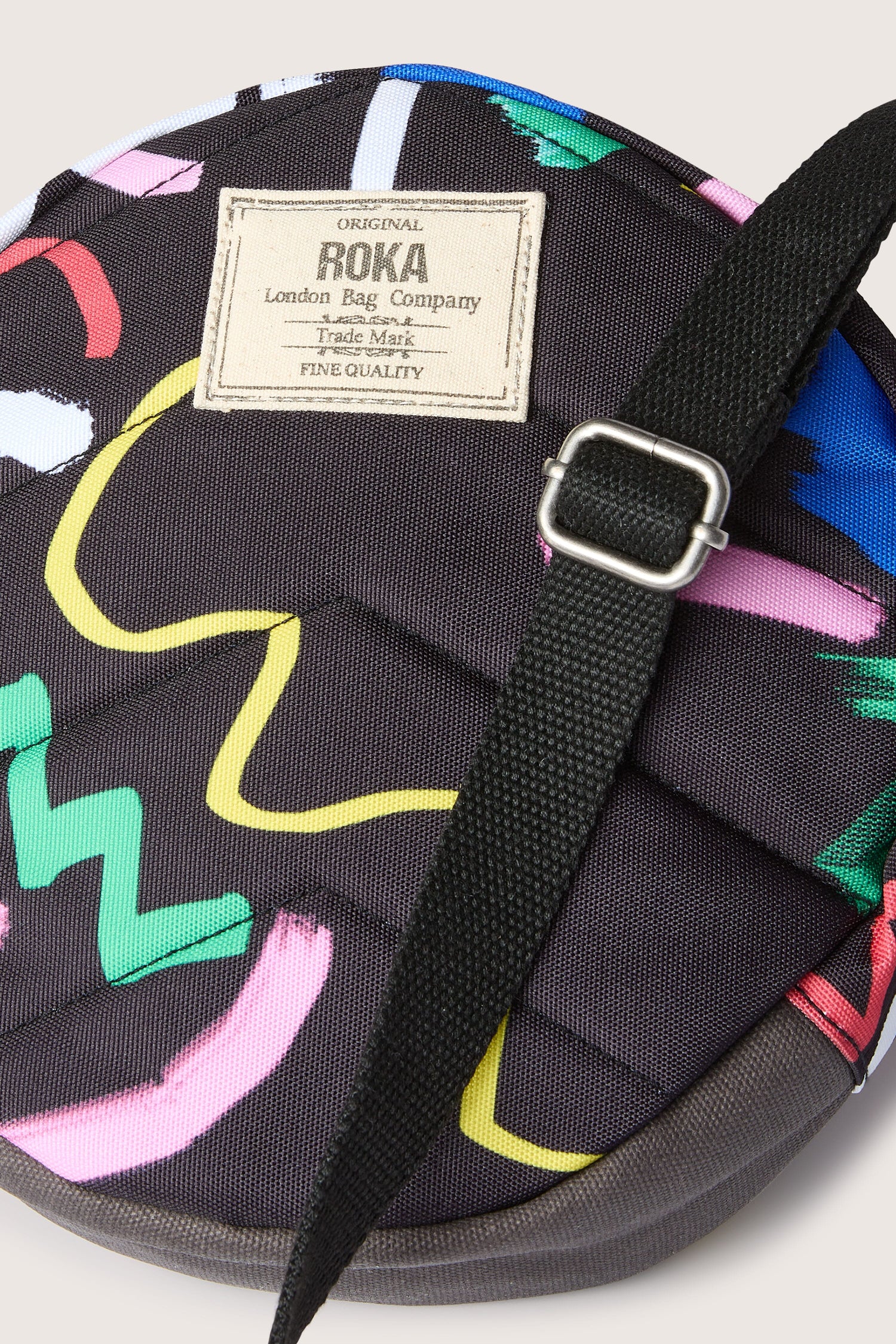 A weather-resistant Recycled Scribble Print Paddington Bag with a colorful design on it.