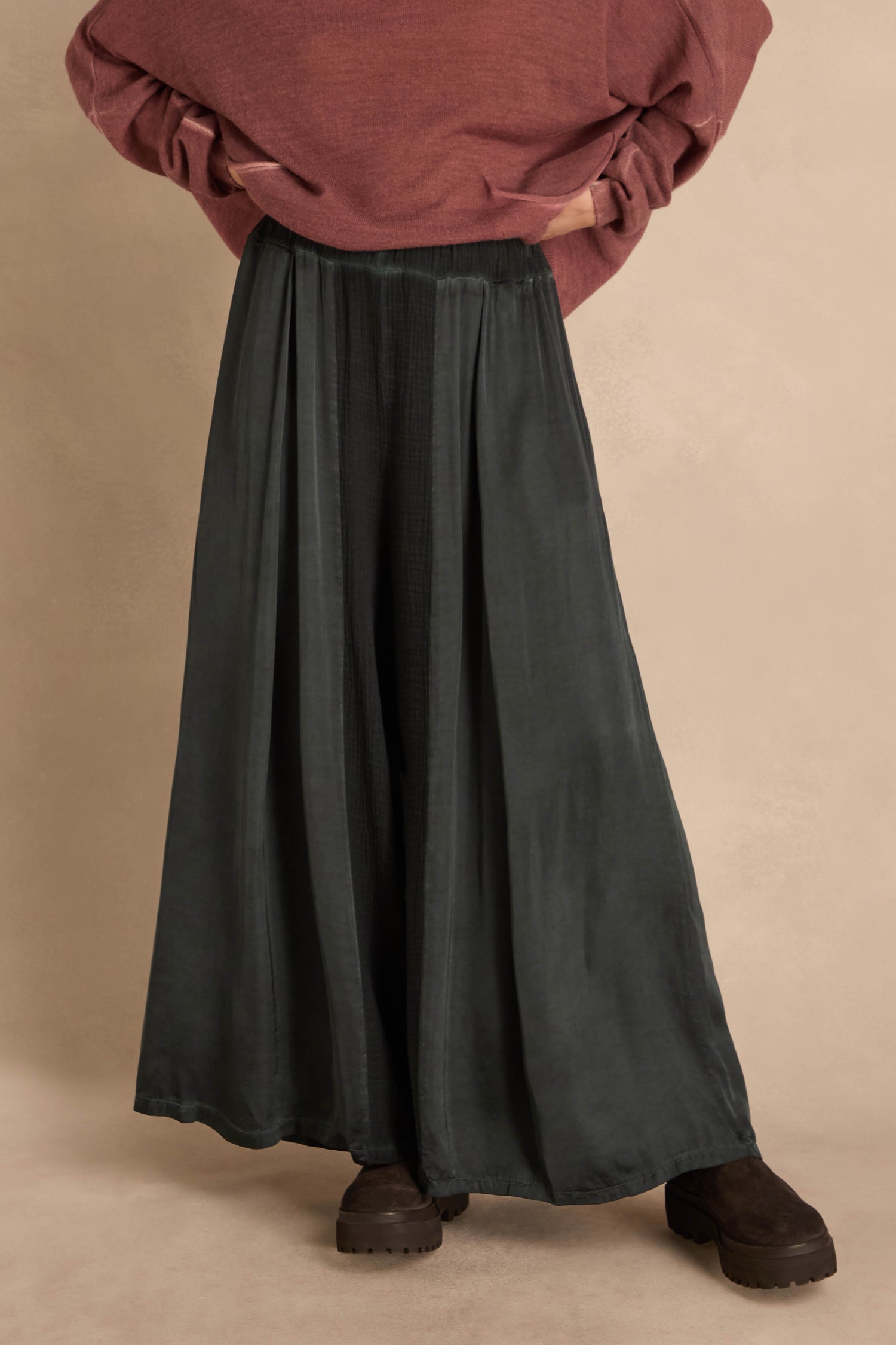Petrol Wide Leg Panel Trousers in dark green with a gathered waist, paired with a maroon sweater and dark brown lug-sole boots.