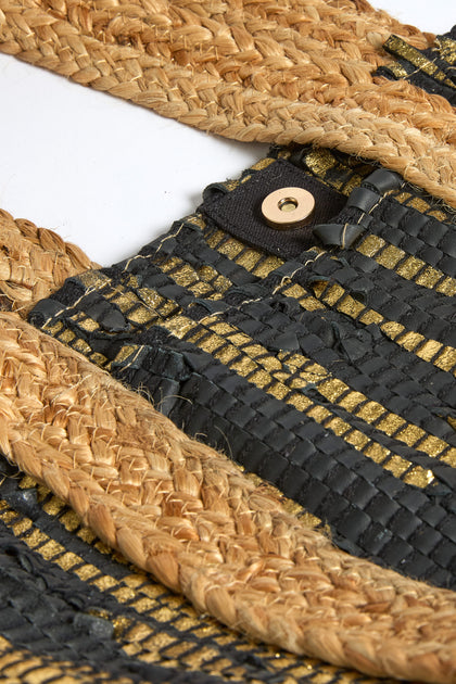 Close-up of the Black and Gold Upcycled Leather Tote Bag, crafted with sustainable techniques and featuring a button closure detail.