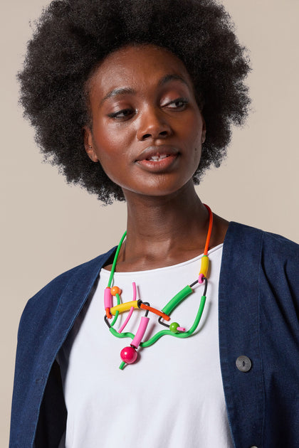 A black woman wearing a Doodle Necklace.