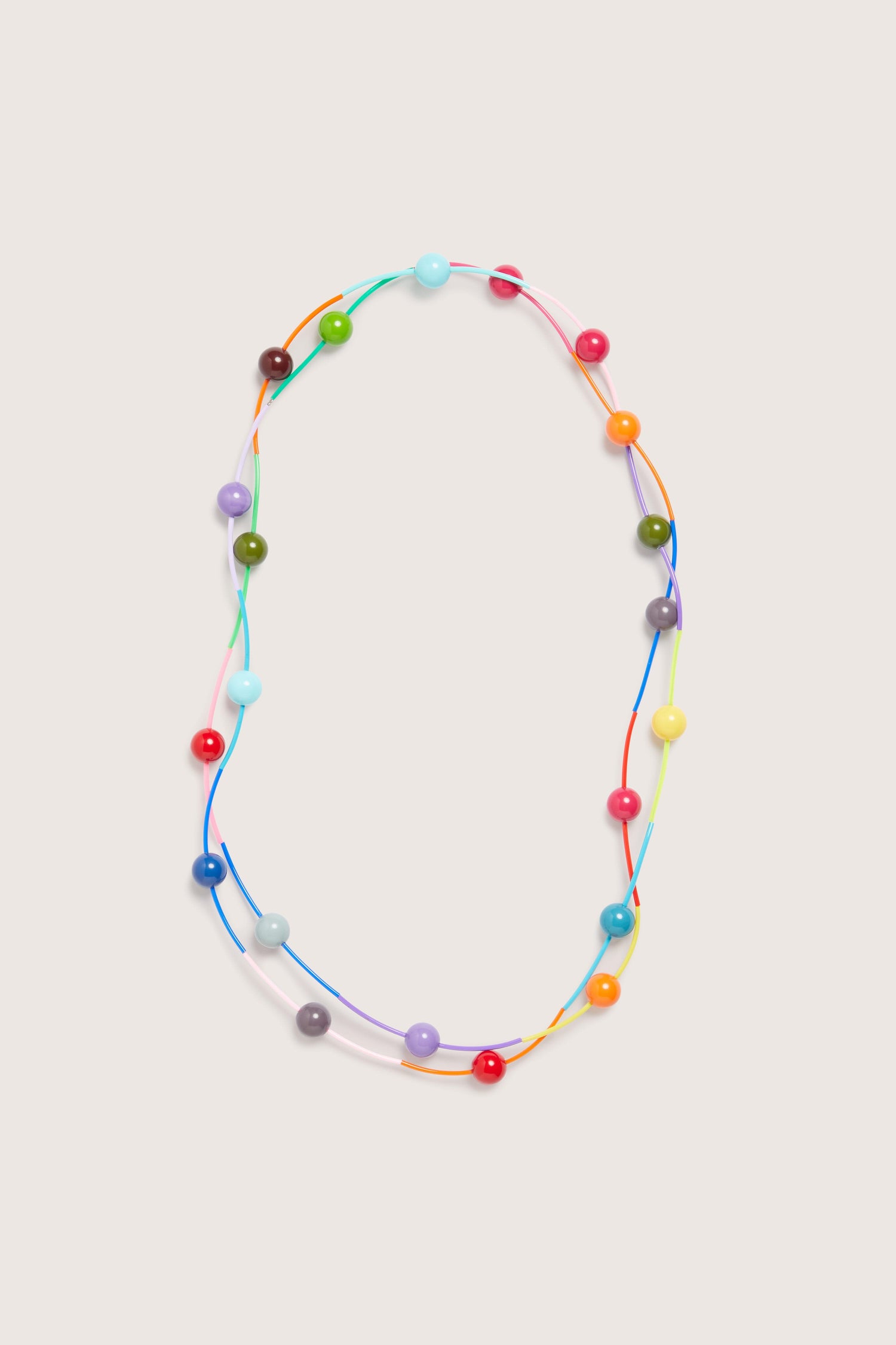 Samuel Coraux's Rainbow Sphere Colour Pop Necklace, featuring vibrant beads arranged in a loop on a white background.