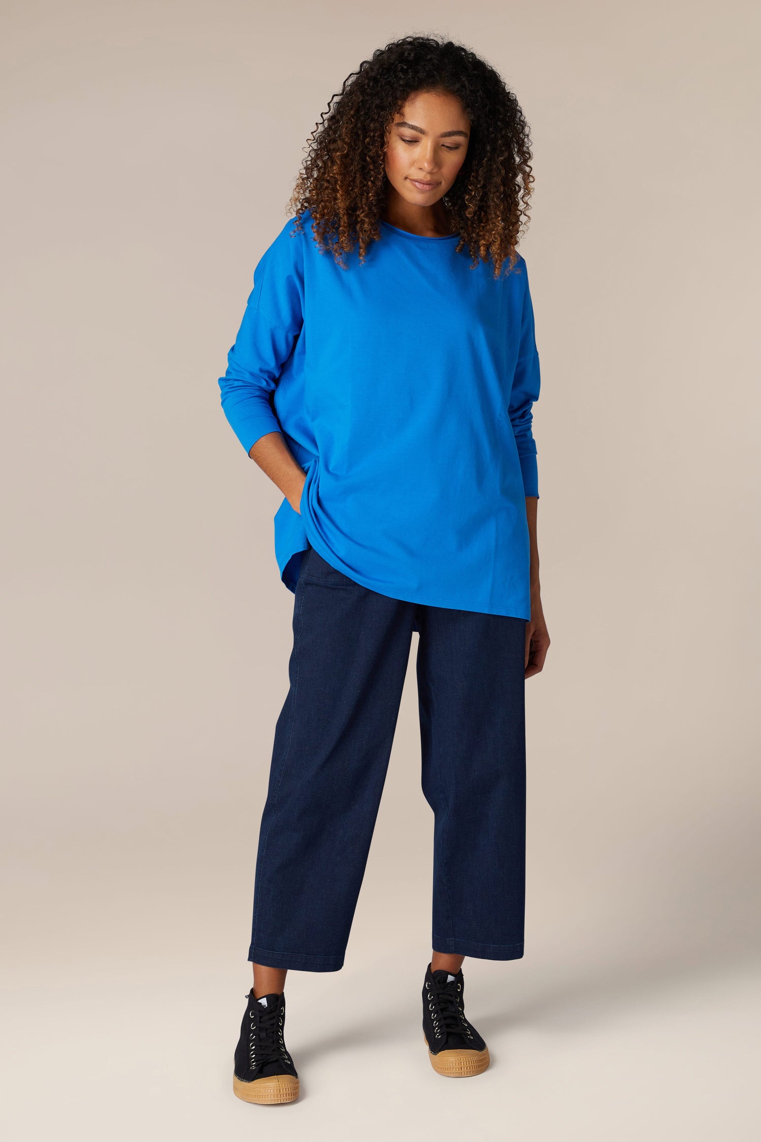 A comfortable woman's wardrobe consisting of a [Cotton Jersey Relaxed Top] in blue and black pants.