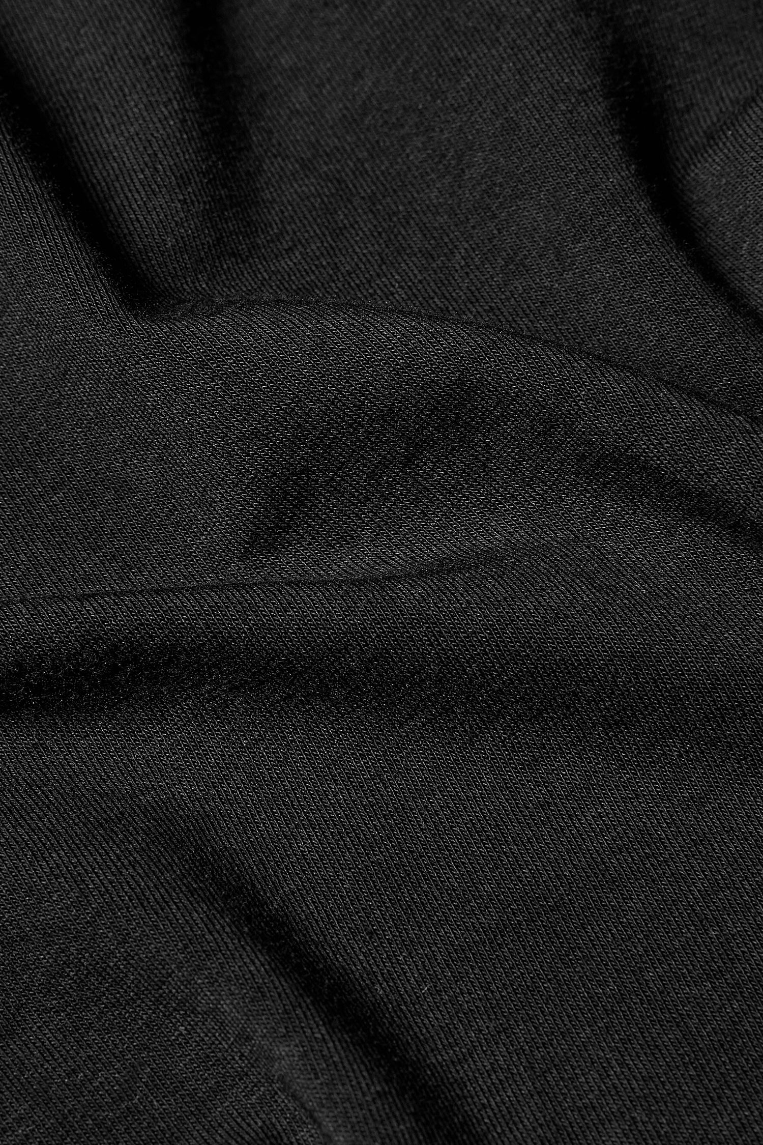 A Cotton Jersey Relaxed Top with an A-line silhouette in a close up of a black sweater made from cotton jersey.