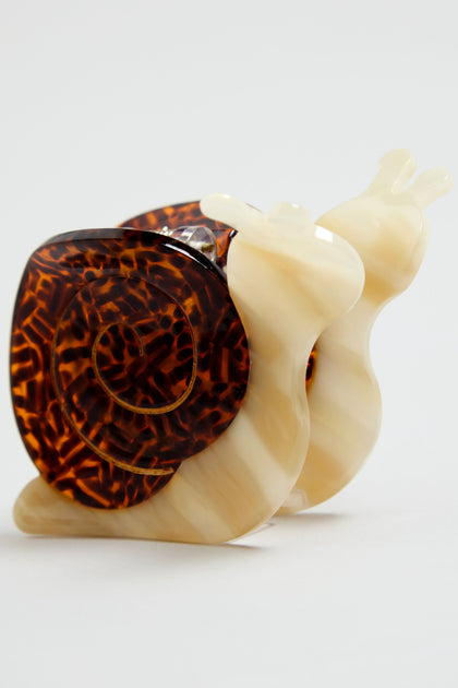The Hand-painted Snail Hair Clip features two snail-shaped clips crafted from glossy, marbled eco-friendly cellulose acetate with amber spiral shells and cream bodies—perfect for a playful, unique hair accessory.