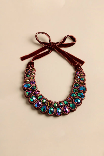 Velvet Ribbon Statement Necklace featuring rows of iridescent crystals set in velvet ribbon with a tied bow at the top.