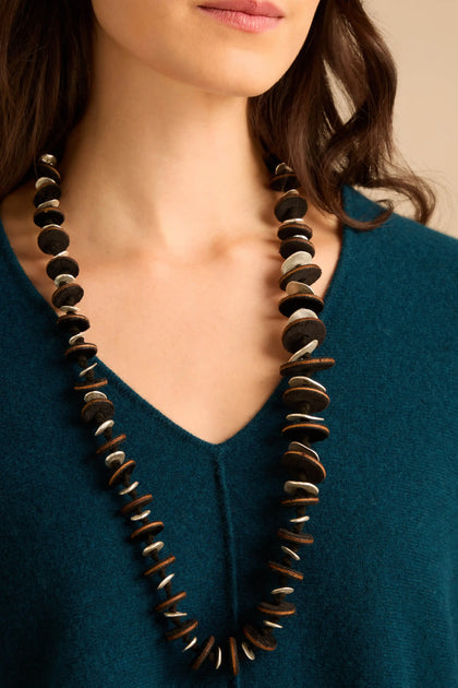 Velvet Detail Disc Necklace consisting of a long cord featuring a series of alternating dark velvet discs and small silver-tone metal discs.