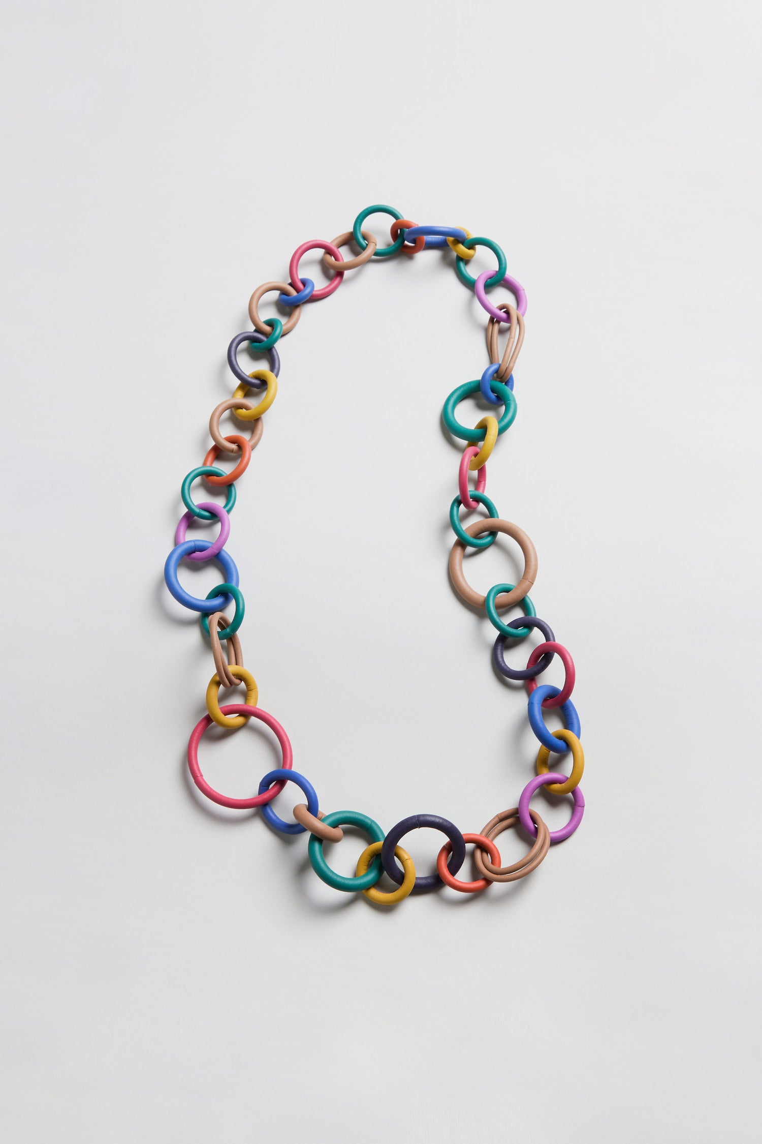 Long Rainbow Hoops Necklace featuring interlocking rubber links in assorted sizes and vibrant rainbow colors, showcased on a plain light background.