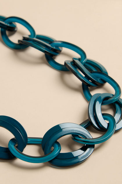 Long Resin Hoop Link Necklace featuring interlocking translucent teal resin hoops.