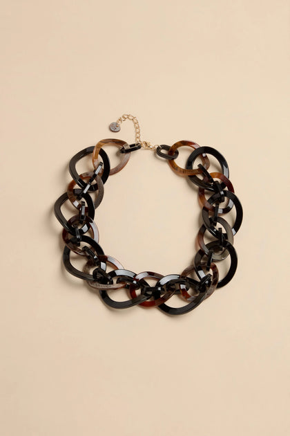Short Resin Link Necklace featuring chunky interlocking black and tortoiseshell resin links with a gold-tone metal extender chain.