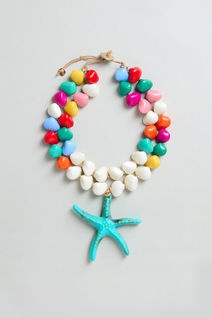 The Turquoise Starfish Pendant Necklace features resin beads, shell accents, and a bold turquoise starfish pendant. Adjustable for the perfect fit, it adds a playful, beachy vibe to your outfit.