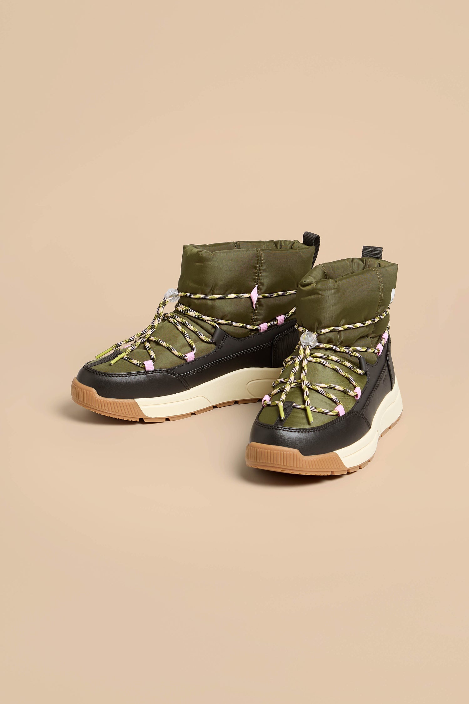 Whitney Quilted Toggle Slip on Boots in olive green with black mudguards, multicolored laces, and thick white and tan insulated soles.