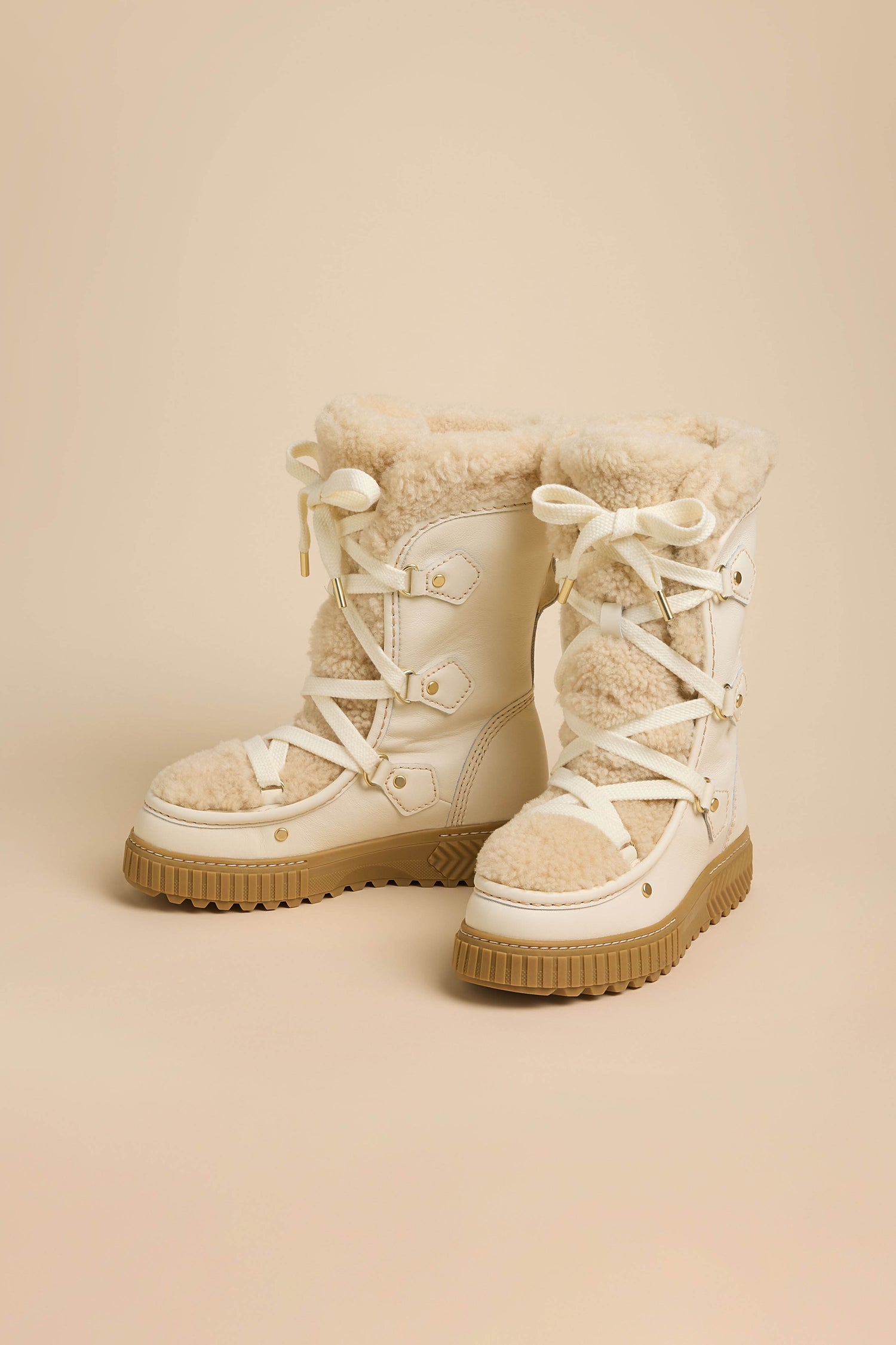 Off-white waterproof Long Leather Alpine Boots with genuine shearling lining and thick, tan lugged rubber soles.