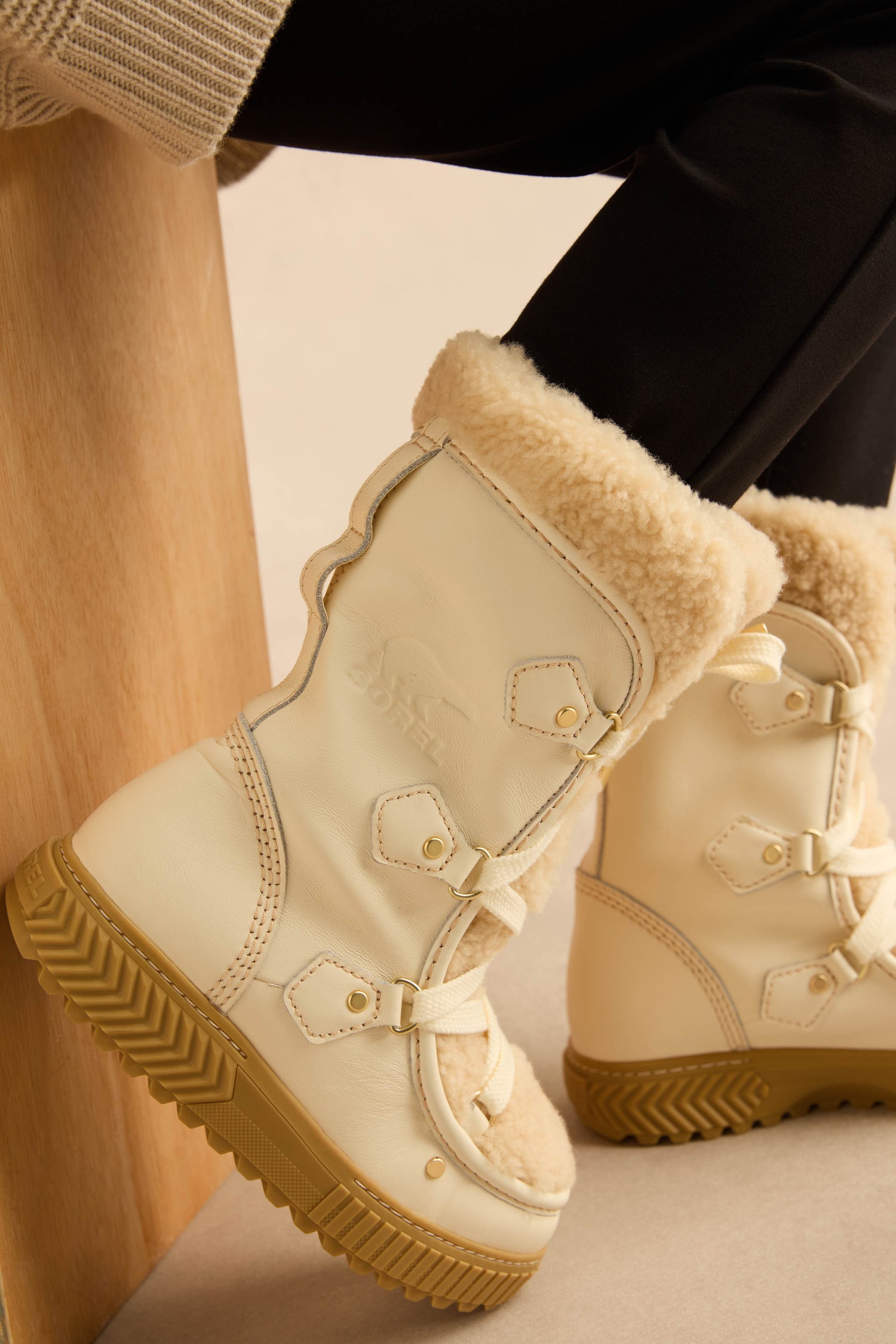 Off-white waterproof Long Leather Alpine Boots with genuine shearling lining, lace-up fronts, and tan rubber soles.