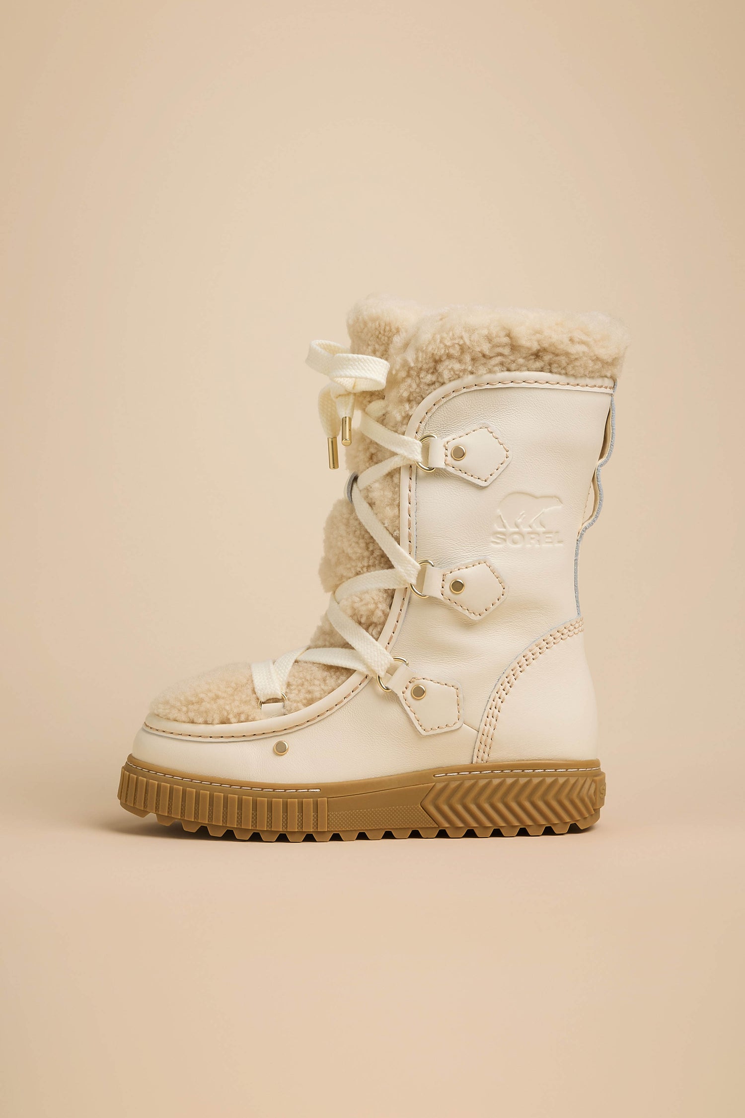 Off-white leather Long Leather Alpine Boots with cream genuine shearling lining, white laces, and a thick brown rubber sole.