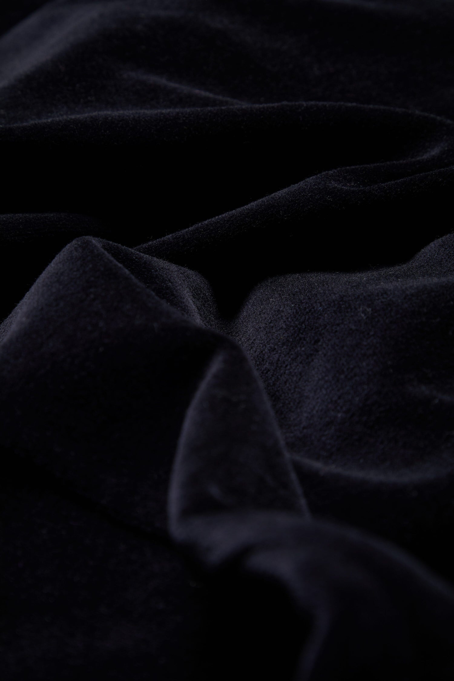 A close up image of a black Velvet Jersey V Neck Dress, exuding luxury.