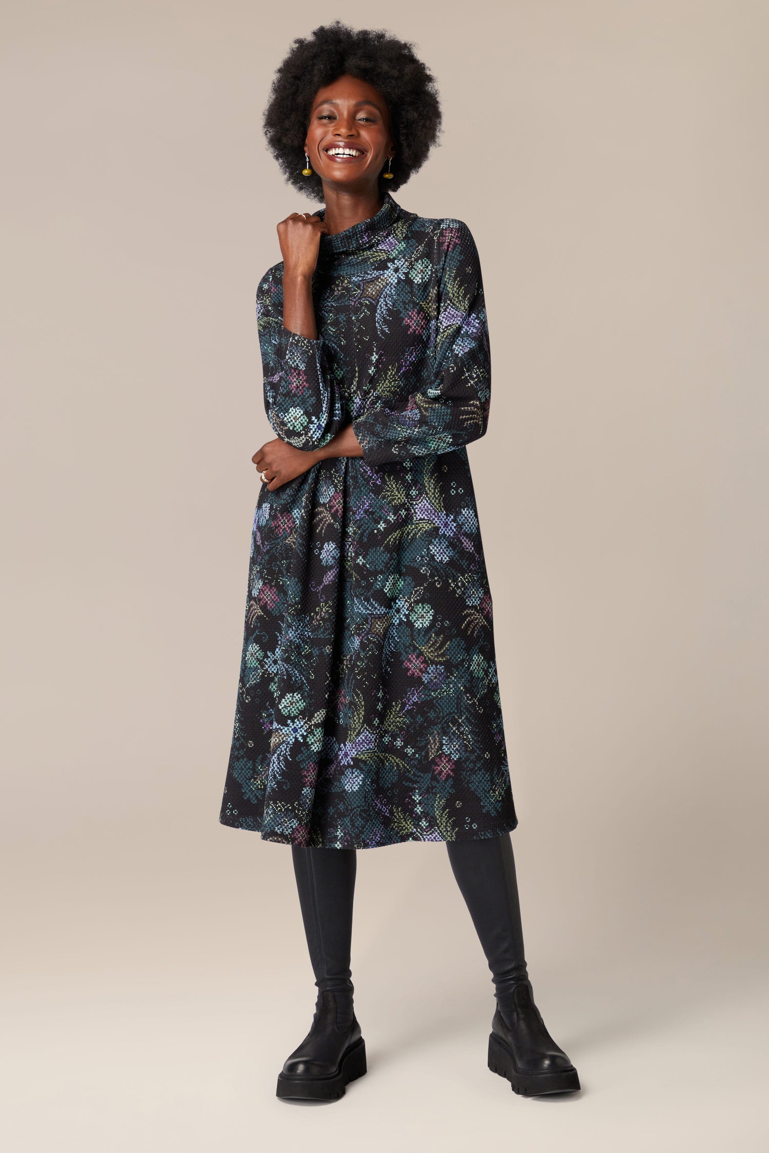 A woman wearing a Pixelated Tapestry Jersey Dress in deep hues.