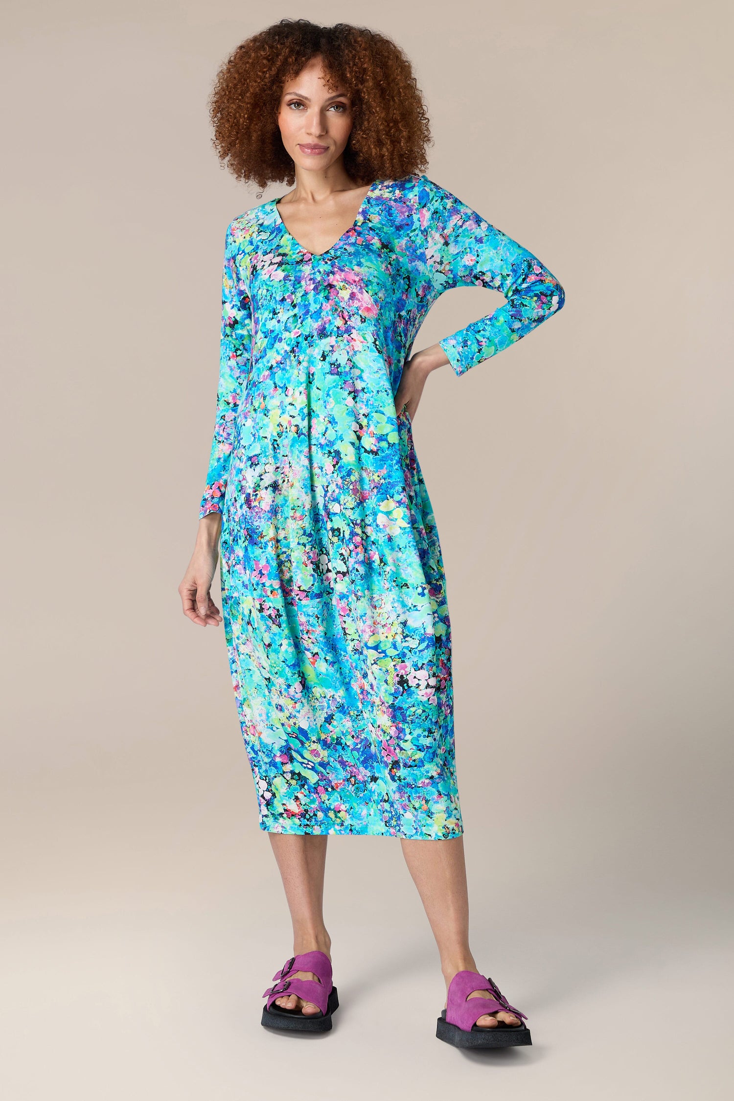 A woman wearing the Spring Petal Burst Jersey Dress made from LENZING™ Viscose ECOVERO™.